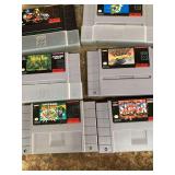 Group of about 15 super Nintendo games.