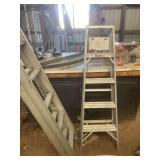 Two aluminum ladders. A 5 foot step ladder and a 24 foot extension ladder.