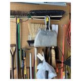 Assorted brooms, shovel, sledgehammer, tamper