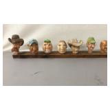 7 Carved Heads on Board 21.5"