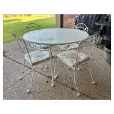 Very nice wrought iron patio set….42-3/4D table with textured glass top and (4) chairs with cushions