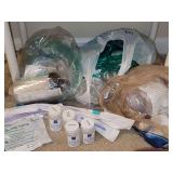 Medical supplies: oxygen tubing, suction canisters, sterile water, and extension tubing