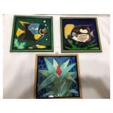 Three pretty framed ceramic tiles. Very colorful. 6.5” Sq. Two tone wood frames.