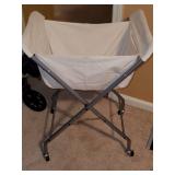 Rolling folding laundry cart. Basket easily removes to be be washed. Has brake on wheels