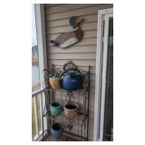 Metal stand with flower pots and duck carving