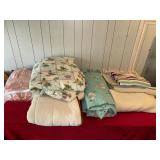 Large amount of old bedding and rugs