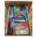 Four drawers of kitchen utensils, kitchen bags, kitchen linens