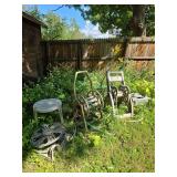 4 garden hose reels and plastic patio table