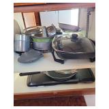 Electric skillet, bunt pans, contents of cupboard -bring box to pack