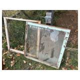 Two antique wood framed windows one glass one chicken wire