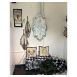 Entry bench, magnolia wreath, basket with rugs and throws, two fishing nets, clipboard wall art and metal decor piece