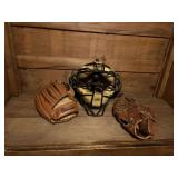 Two leather ball gloves and a catchers mask