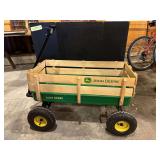 Green coaster wagon with big tires, wood sides and John Deere decals