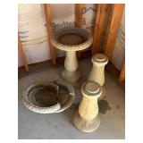 Three concrete birdbath one top is broken