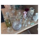 Assorted vases, etched glasses, candle sticks, and miscellaneous glassware