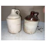 2 stoneware jugs.  One with lump on the bottom