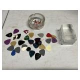 Assorted guitar pics with ashtray and paperweight