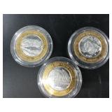 3 $10 silver and brass gaming tokens with each hav