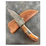 Damascus bladed knife with wood scales and leather