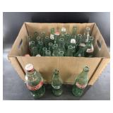 Large box full of vintage empty Coca Cola glass bo