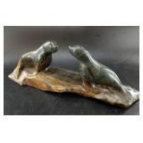 Soapstone carving of a pair of seals set on an ice