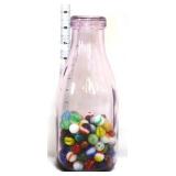 Vintage glass milk bottle with marbles inside