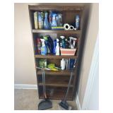 Book shelf with cleaning supplies.