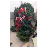 Christmas greenery and three wreaths