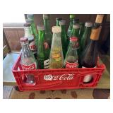 Plastic Coca-Cola crate and vintage bottles