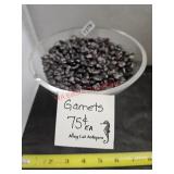 Glass pedestal dish full of garnets