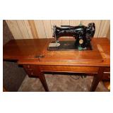 Vintage Singer sewing machine in cabinet