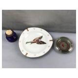 Ash tray, goose plate, and empty blue bottle with