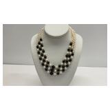 Three strand black and white pearl necklace with