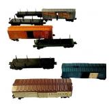 EIGHT LIONEL BOXCARS AND FLATBEDS