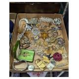 Flat of costume jewelry pins watches etc